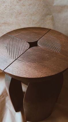 a wooden table sitting on top of a white sheet