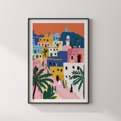 an art print hangs on the wall next to a potted plant in front of a window