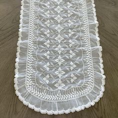 a white doily is laying on a wooden floor