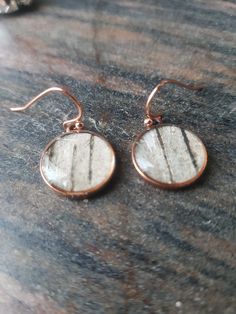 a pair of earrings sitting on top of a table