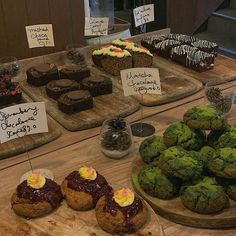 there are many different desserts on display at the bakery counter, including cakes and muffins