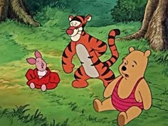 winnie the pooh and piglet playing with each other in the grass near some trees