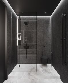 a black and white bathroom with marble flooring, glass shower stall and sink area