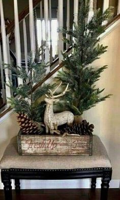 a small christmas tree sitting on top of a bench in front of a banister