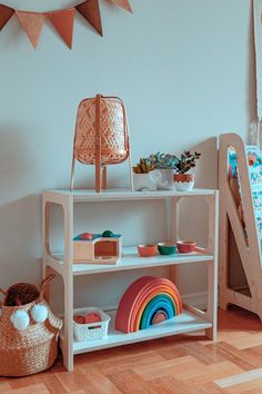 a white shelf with toys and other items on it in a child's room