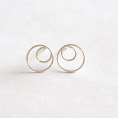 This a wonderfully simple and minimalistic earring for everyday use. The open circle is 7mm in diameter making it a perfect and understated piece. It is made with solid sterling silver, 14k gold filled, and 14k rose gold filled. These are all great options if you have sensitive ears! <> Large Circle Outer diameter - 12mm <> Small Circle Outer Diameter - 7mm <> Materials - Titanium, .925 Sterling Silver, Yellow Gold Fill, Rose Gold Fill, 14k Gold, 14k White Gold, 14k, Rose Gold, Circle Stud Earrings, Small Circle, Circle Earrings Studs, Circle Studs, Gold Filled Earrings, Sensitive Ears, Stud Earring, Earrings Jewelry, Gold Filled