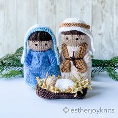 two knitted nativity figurines sitting next to each other