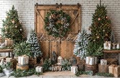 christmas trees and presents are arranged in front of a brick wall with a wooden door