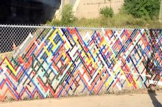 a fence made out of strips of colored paper