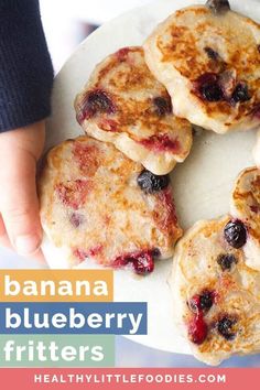 blueberry pancakes on a white plate with the words, banana blueberry fritters