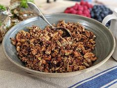 a bowl filled with granola sitting on top of a table