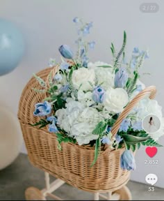 a wicker basket filled with white and blue flowers