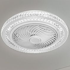 a white ceiling fan mounted to the side of a wall