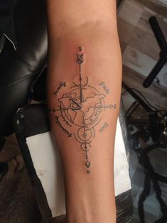 a person with a compass tattoo on their arm