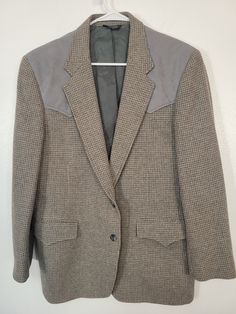 Howdy dudes! It's Western Wear Weekend at PO! Here's a Vintage 1980s Panhandle Slim western gray wool houndstooth two-button sport coat jacket. Tag says men's 42L, made in USA Gray faux suede western yoke. Thick weave fabric. Fully lined. Red trim piping inside. Near mint condition, didn't see a problem on it even in the pits.  Please see our other listings for more vintage western garments with new items added nearly daily. PLEASE check the measurements as vintage clothing sizes may not comparable to contemporary sizes. Measurements: Label size: 42R Shoulder-to-shoulder: 18" Chest across: 21" Sleeve from shoulder: 24" Length in back from base of collar: 29" Pete's Obsolete is smoke-free. We present garments as honestly as possible and point out any known flaws. We leave cleaning and/or re 1980s Mens Fashion, Mens Sport Coat, Weave Fabric, Vintage Western, Vintage Textiles, Men's Coats And Jackets, Vintage Wool, Western Wear, Sport Coat