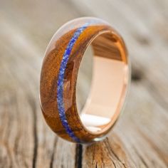 a wooden ring with blue stripes on it