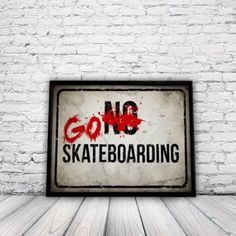 a sign that says go skateboarding on it in front of a white brick wall