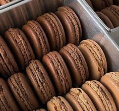 a box filled with lots of chocolate macaroons