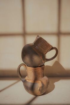 an old vase sitting on top of a table next to a tiled wall and floor