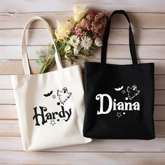 two black and white bags with the word dianna printed on them next to flowers