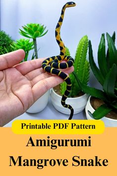 a hand holding a small yellow and black snake in it's right hand with the words printable pdf pattern