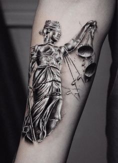 a lady justice tattoo on the arm