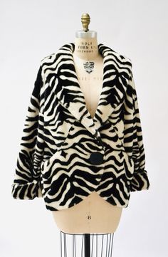 "Rock your style in this amazing faux fur jacket from the 90s: * Black and off-white zebra stripes in Faux fur * Front Button closure * permanent cuffed sleeves * Full lining * front pockets * Super awesome and a great statement piece Brand Apparence Paris Size LARGE 100% acrylic faux fur, made in the France Good Vintage condition with a makeup stain on the fur UNDER the collar, only visible if collar is worn up. Price is reflective Body Length 28\" Chest 48\" Waist/bottom opening 48\" Sleeve le Zebra Print Outfit Ideas, Chic Striped Winter Outerwear, Vintage Striped Winter Outerwear, Zebra Print Outfits, Black 80s Fashion, Zebra Print Clothes, Gothic Coat, Jacket Black And White, 90s Glam