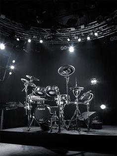 black and white photograph of drum set on stage