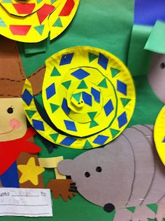 some paper plates and other items on a green tablecloth with yellow circles, stars, and shapes