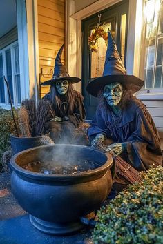 two witches sitting in front of a large pot