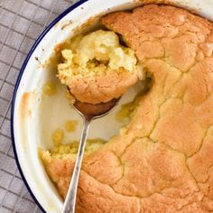 a close up of a cake in a pan with a spoon