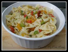 a white bowl filled with pasta and vegetables