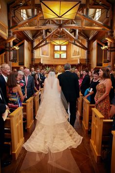 the bride and groom are walking down the aisle