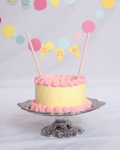 a birthday cake with pink frosting and two candles