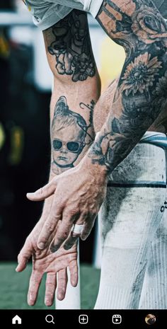 a man with tattoos on his arms and hands