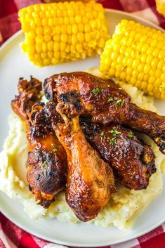 chicken wings, mashed potatoes and corn on the cob are ready to be eaten