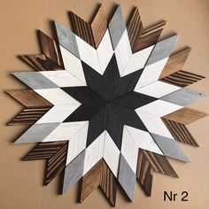 a large wooden star hanging on the wall next to a brown and white sign that says n 2