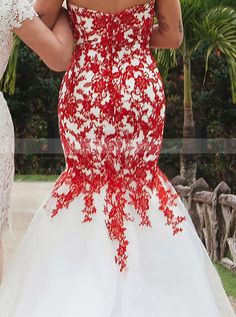 a woman in a red and white wedding dress