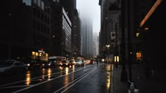 a city street filled with lots of traffic on a rainy day in the middle of the night