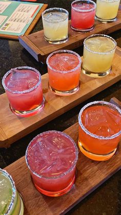 several different types of drinks on wooden trays