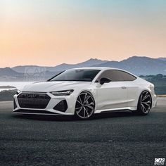 a white car parked on the side of a road next to some mountains and water