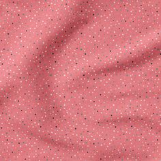 a pink and black polka dot fabric with small white dots on the top of it