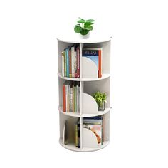 a white shelf with books and a potted plant