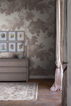 a bedroom with a dresser and pictures on the wall