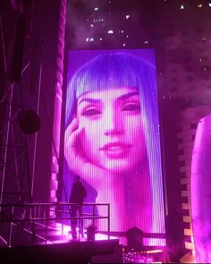 a large screen with a woman's face on it