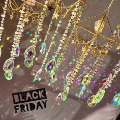 a chandelier hanging from the ceiling with stars and jewels on it that says black friday