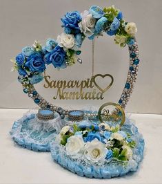 a blue and white centerpiece with flowers on it