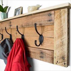 the coat rack is made out of wood and has hooks on it