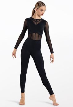 a woman in a black leotard with sheer - top and leggings