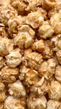 a pile of caramel popcorn sitting on top of a wooden table